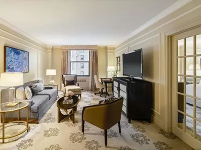 a living room with a couch and a tv at Fairmont Hotel Vancouver in Vancouver