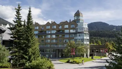 a large building with a tower on top of it at Le Chamois by Whistler Premier in Whistler