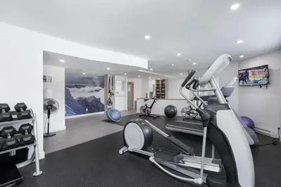 a gym with a treadmill and exercise equipment at Le Chamois by Whistler Premier in Whistler