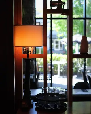 a lamp sitting on a table next to a window at Oswego Hotel in Victoria