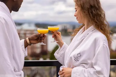 a man and a woman holding glasses of orange juice at Oswego Hotel in Victoria