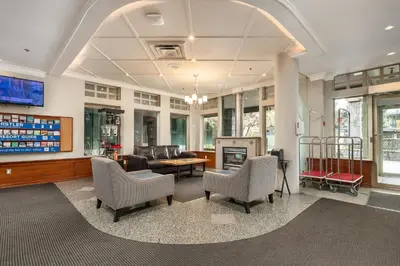 a waiting room with chairs and a tv at Pinnacle Hotel Whistler in Whistler