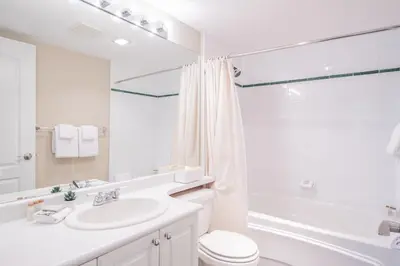 a bathroom with a sink and a toilet and a shower at Deer Lodge by Outpost Whistler in Whistler
