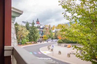 a view from a balcony of a street with a building at Deer Lodge by Outpost Whistler in Whistler