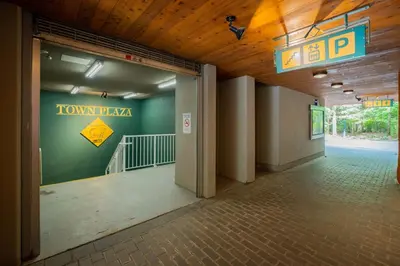 an empty hallway in a building with a sign on the wall at Deer Lodge by Outpost Whistler in Whistler