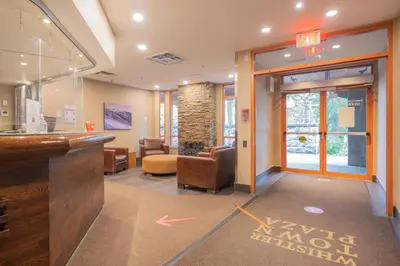a lobby with a bar and a waiting room at Deer Lodge by Outpost Whistler in Whistler