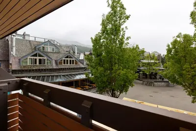a view of a town from a balcony of a building at Blackcomb Lodge in Whistler