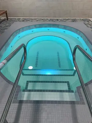 a pool in a house with a tile floor and a swimming pool at Blackcomb Lodge in Whistler
