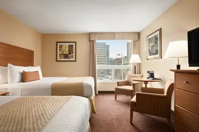 a hotel room with two beds and a window at Days Inn by Wyndham Edmonton Downtown in Edmonton
