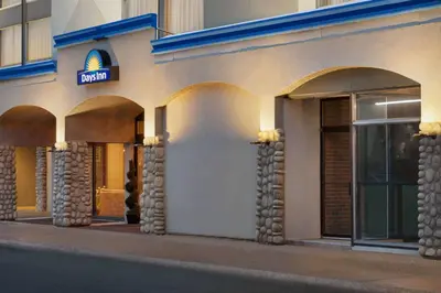 a building with a sign on the side of it at Days Inn by Wyndham Edmonton Downtown in Edmonton
