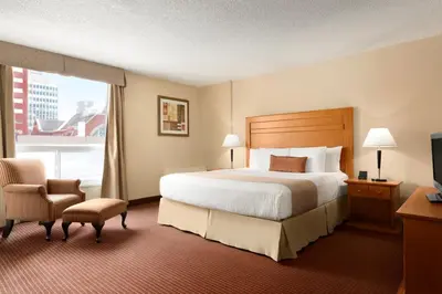 a hotel room with a bed and a window at Days Inn by Wyndham Edmonton Downtown in Edmonton