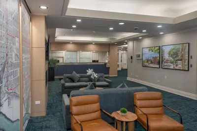 a lobby with couches and chairs and a waiting room at Campus Tower Suite Hotel in Edmonton