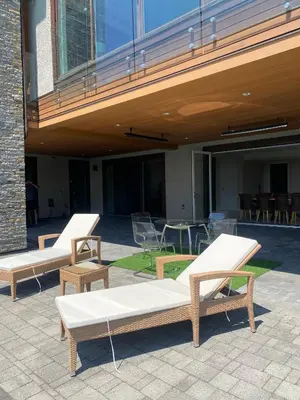 two benches and a table and chairs under a building at Luxury accomodation in West Vancouver in West Vancouver