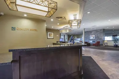 a lobby at a quality hotel with a reception desk at Quality Hotel & Conference Centre in Fort McMurray