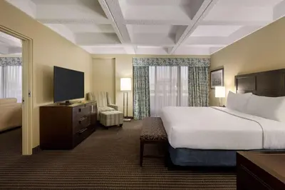 a hotel room with a bed and a television at Wyndham Edmonton Hotel and Conference Centre in Edmonton