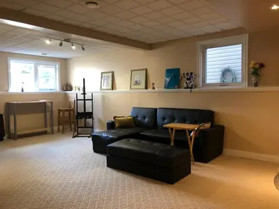a living room with a black couch and a table at Citadel hill cr community! in Calgary