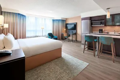 a hotel room with a bed and a kitchen at Residence Inn by Marriott Vancouver Downtown in Vancouver