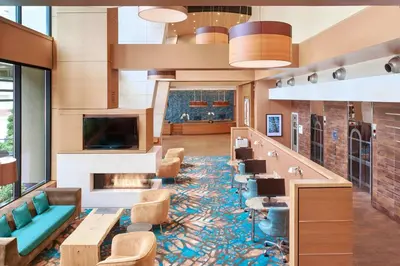 a lobby with a waiting area with chairs and a tv at Residence Inn by Marriott Vancouver Downtown in Vancouver