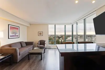 a living room with a couch and a table at Executive Hotel Vancouver Airport in Richmond