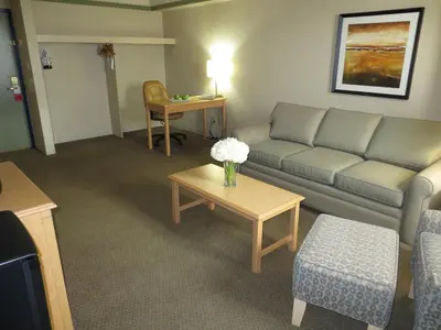 a living room with a couch and a table at Edmonton Inn and Conference Centre in Edmonton