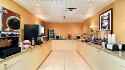 a large kitchen with a counter and aasteryasteryasteryasteryasteryasteryasteryastery at Abercorn Hotel, Trademark Collection by Wyndham in Richmond