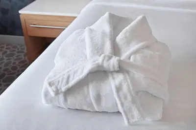 a white towel sitting on top of a bed at Delta Hotels by Marriott Calgary Downtown in Calgary