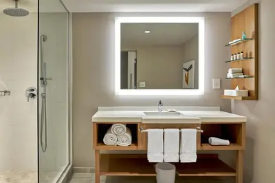 a bathroom with a sink and a mirror at Delta Hotels by Marriott Calgary Downtown in Calgary