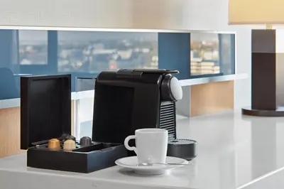 a desk with a coffee maker and a cup on it at Delta Hotels by Marriott Calgary Downtown in Calgary