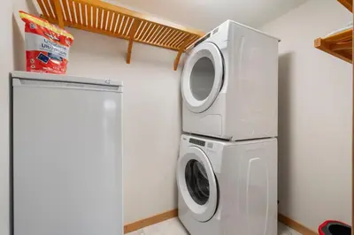 a washer and dryer in a laundry room at Spring Creek Penthouse by Canadian Rockies Vacation Rentals in Canmore