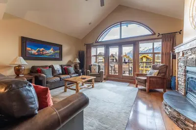 a living room with a couch and a fireplace at Cascade Penthouse by Canadian Rockies Vacation Rentals in Canmore