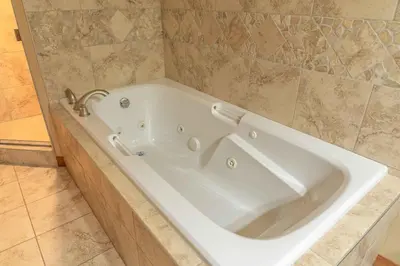 a large white bath tub in a bathroom at Cascade Penthouse by Canadian Rockies Vacation Rentals in Canmore