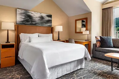 a hotel room with a bed and a couch at The Westin Resort & Spa, Whistler in Whistler