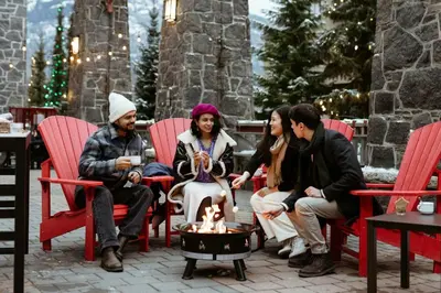 a group of people sitting around a fire pit at The Westin Resort & Spa, Whistler in Whistler