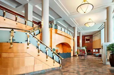 a lobby with a staircase in a building at Sheraton Suites Calgary Eau Claire in Calgary