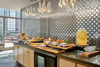 a kitchen with a counter with food on it at Sheraton Suites Calgary Eau Claire in Calgary