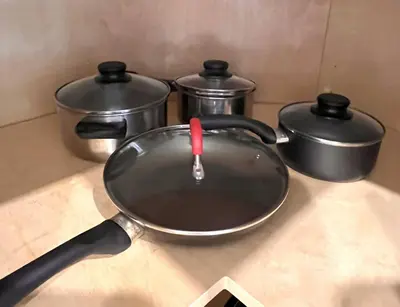 a pan sitting on a counter with two pots at Victory House in Burnaby