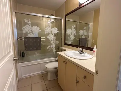 a bathroom with a toilet and a sink and a shower at Victory House in Burnaby