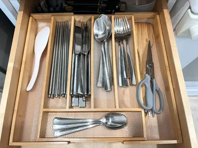 a drawer with utensils in a wooden box at Victory House in Burnaby