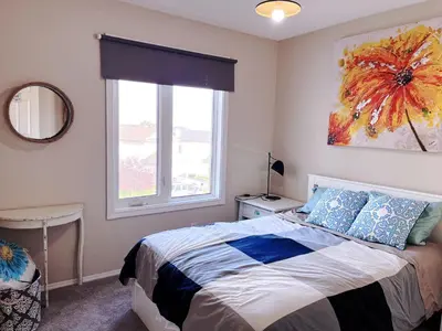 a bedroom with a bed and a window at Banff -Calgary Garden &3 mins Bus station Close C-Train&Free Parking in Calgary