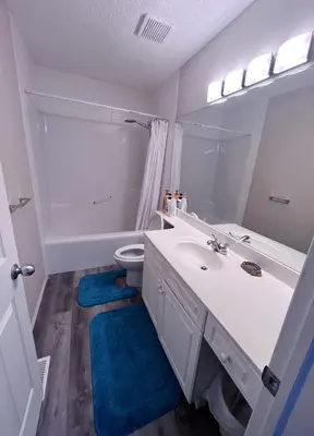 a white bathroom with a sink and a toilet at Banff -Calgary Garden &3 mins Bus station Close C-Train&Free Parking in Calgary