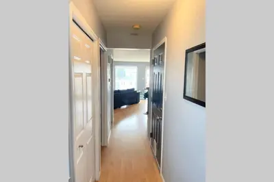 a hallway leading to a living room with a couch at Spacious Duplex in Camrose