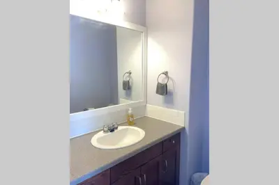 a bathroom with a sink and a mirror at Spacious Duplex in Camrose