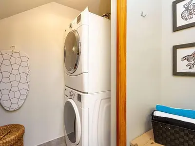 a laundry room with a washer and dryer at Updated Townhouse in Village. Pool/Hot Tub/Parking in Whistler