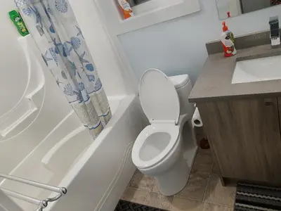 a small bathroom with a toilet and a sink at Guest Suite Private Retreat for 2 Guests With AC - 4 Units Available in Abbotsford