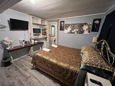 a bedroom with a bed and a desk with a computer at Guest Suite Private Retreat for 2 Guests With AC - 4 Units Available in Abbotsford