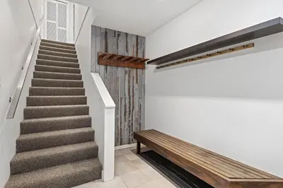 a staircase with a wooden bench and a stair case at 2BR in Gleneagle, Gourmet Kitchen, Newly Updated, Wood Burning Fireplace, Parking in Whistler