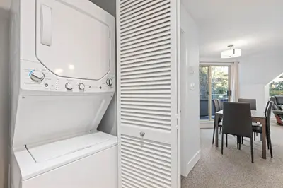 a kitchen with a refrigerator and a dining room at 2BR in Gleneagle, Gourmet Kitchen, Newly Updated, Wood Burning Fireplace, Parking in Whistler