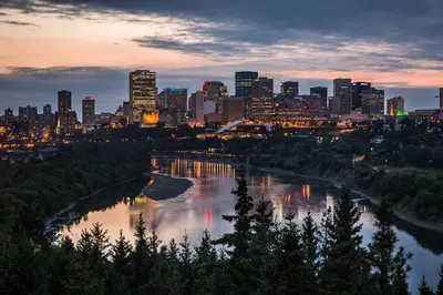 a city skyline with a river in front of a city at Stylish Chic Home - King Bed - Free Parking & Netflix - Fast Wi-Fi - Long Stays Welcome in Edmonton