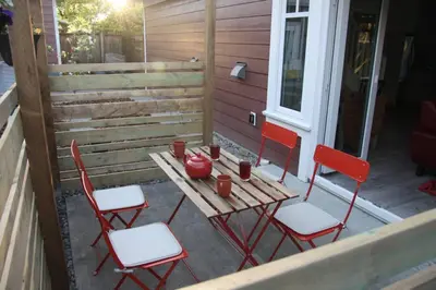 a table and four chairs on a porch at Vancouver Traveller Cottage in Vancouver