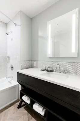 a white bathroom with a sink and a tub and a toilet at Mount Royal Hotel in Banff